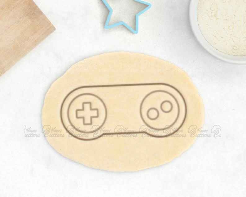 Retro Video Game Cookie Cutter – Video Game Controller Cookie Cutter Retro Gaming Gift, xbox controller cookie cutter, xbox cookie cutter, ps4 controller cookie cutter, ps4 cookie cutter, nintendo cookie cutters, minecraft fondant cutter, bow tie cookie cutter, sea life cookie cutters, snoopy cookie cutter, bear head cookie cutter, boat cookie cutter, feminist cookie cutters, cookie shapes, castle cookie cutter, happy cutters, best cookie cutters